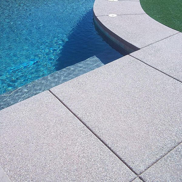 Backyard concrete firepit with concrete planters and bench.